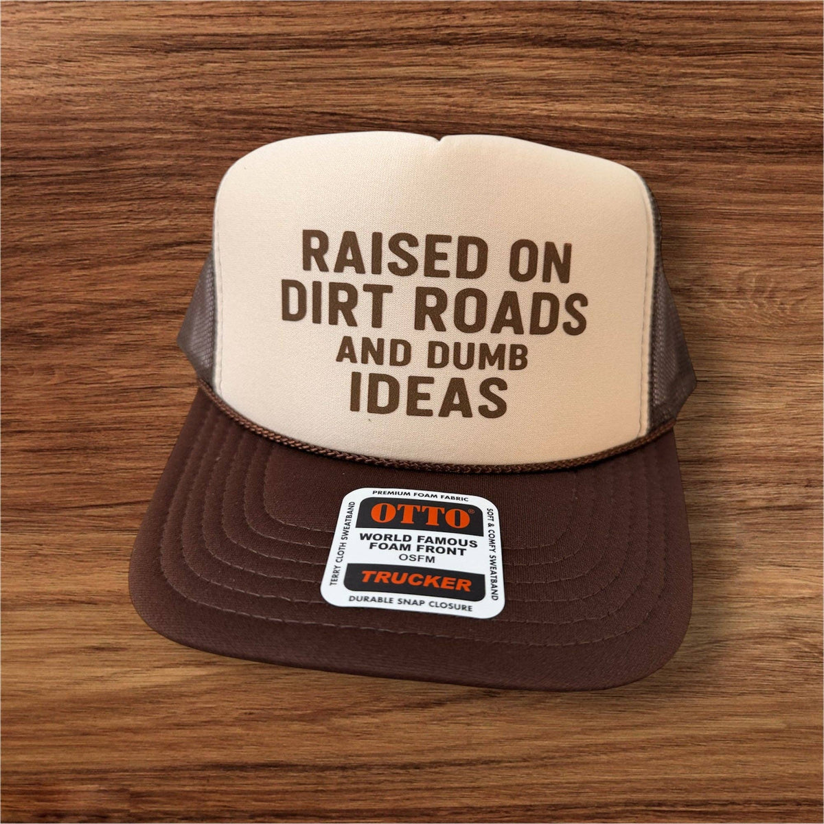 "RAISED ON DIRT ROADS and dumb ideas" Printed Brown and Tan Trucker Hat